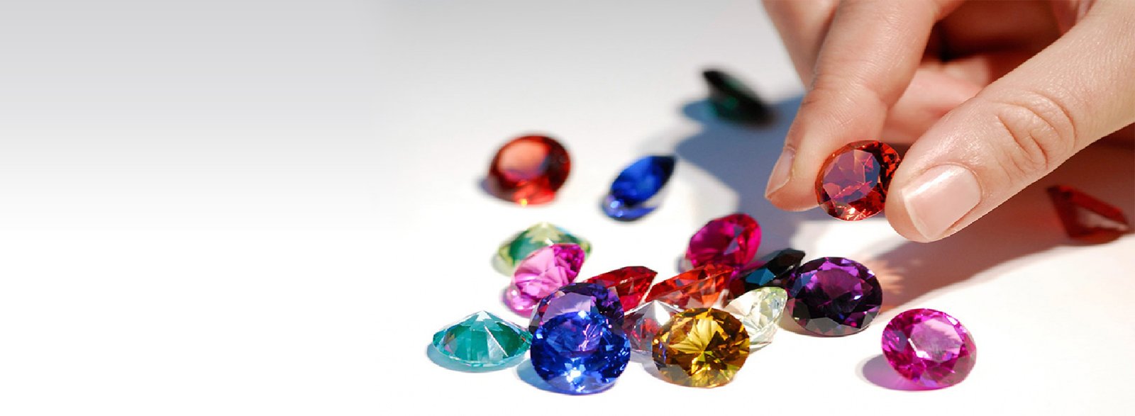 A curated selection of colorful faceted gemstones